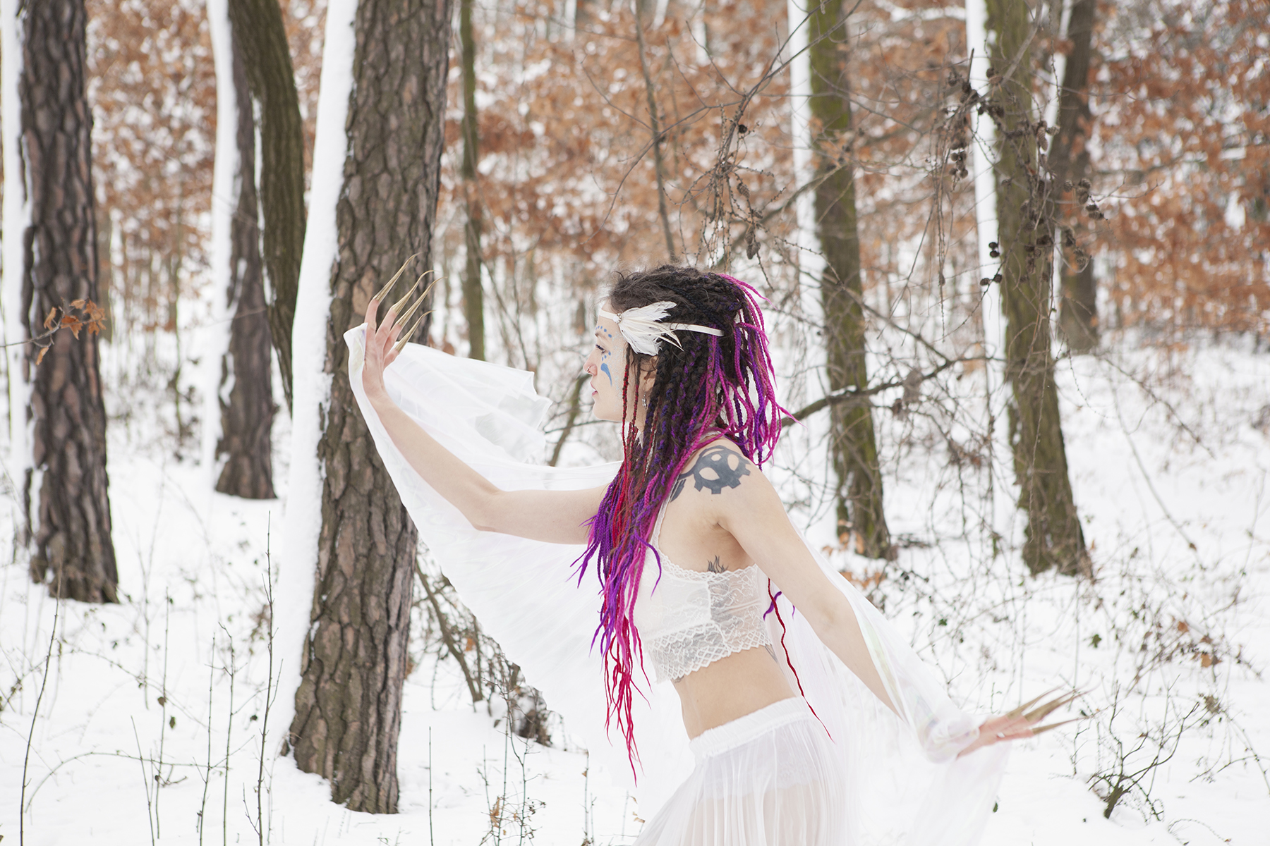 A photo of a purple hair fairy, wearing white, dancing in the forest in the sone